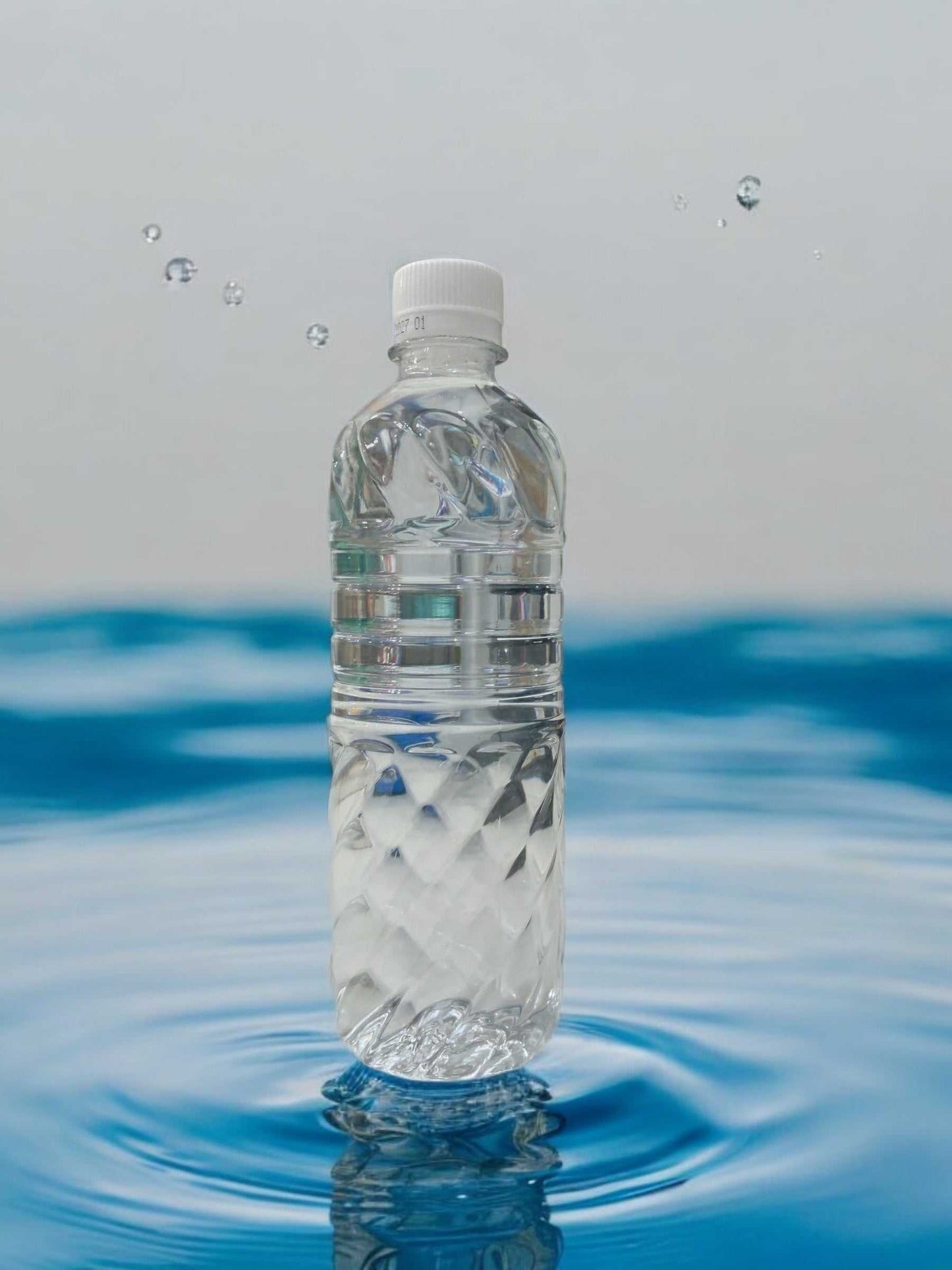 KS natural mineral water 500ml clear plastic bottle floating on water surface