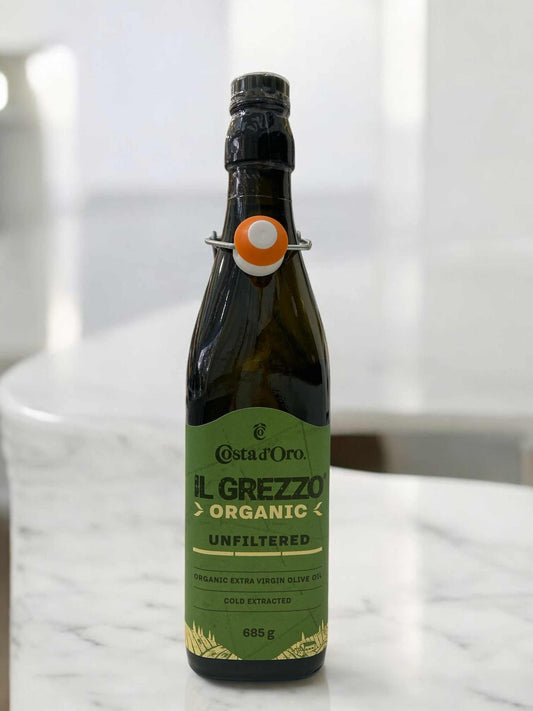 Costa d'Oro Il Grezzo Organic unfiltered extra virgin olive oil 685g bottle on marble surface