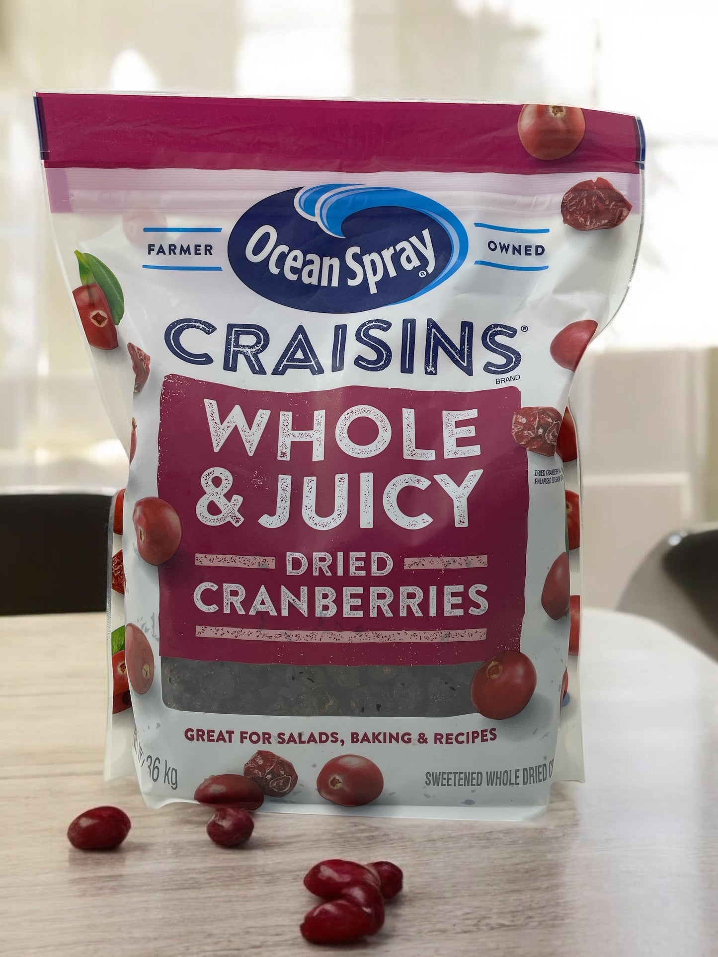 Ocean Spray Craisin Whole & Juicy Dried Cranberries 1.36kg package on table.