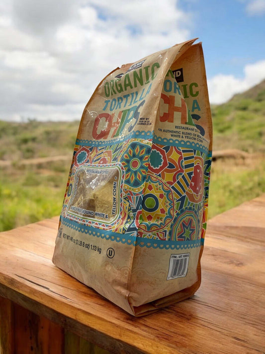 Organic tortilla chips 1.13kg bag made with gluten-free white and yellow corn, ideal for snacking or pairing with dips and salads.