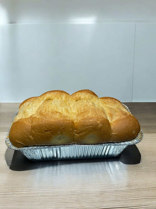 Loaf of rich and fluffy Hotel Bread made with butter, eggs, and milk in aluminum tray, limited edition Costco bakery product